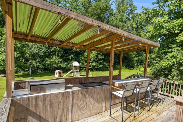 2021 Tarzi Ln, Charlotte, NC 28215 - wooden terrace with a lawn, a playground, area for grilling, and view of wooded area