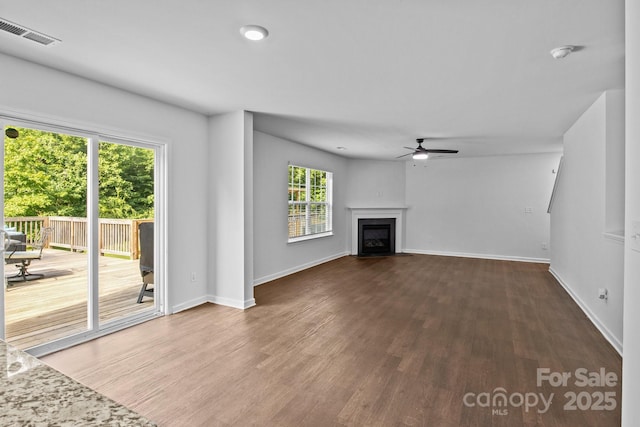 2021 Tarzi Ln, Charlotte, NC 28215 - unfurnished living room with ceiling fan, wood finished floors, and a fireplace with flush hearth
