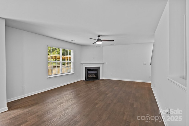 2021 Tarzi Ln, Charlotte, NC 28215 - unfurnished living room featuring a ceiling fan, dark wood-style floors, and a fireplace with flush hearth