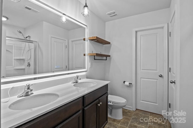2021 Tarzi Ln, Charlotte, NC 28215 - full bath with double vanity, a shower with door, and stone finish floors
