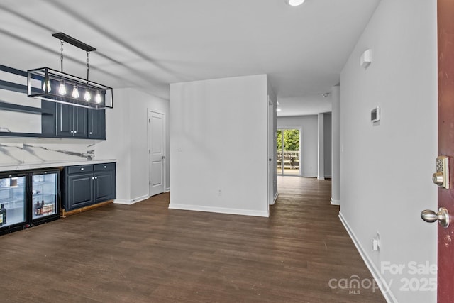 2021 Tarzi Ln, Charlotte, NC 28215 - kitchen with dark wood-style flooring, light countertops, wine cooler, and blue cabinets