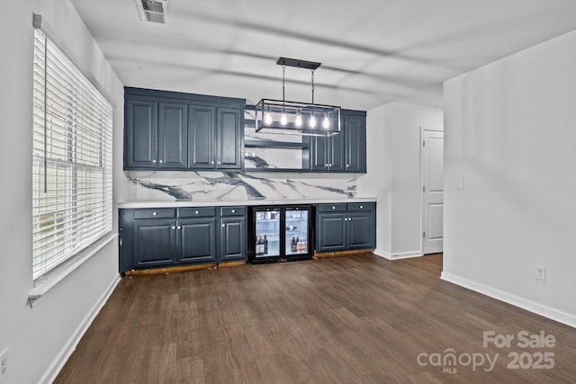 2021 Tarzi Ln, Charlotte, NC 28215 - kitchen featuring wine cooler, dark wood-type flooring, and light countertops
