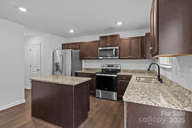 2021 Tarzi Ln, Charlotte, NC 28215 - kitchen featuring stainless steel appliances, a kitchen island, dark wood-type flooring, dark brown cabinets, and recessed lighting
