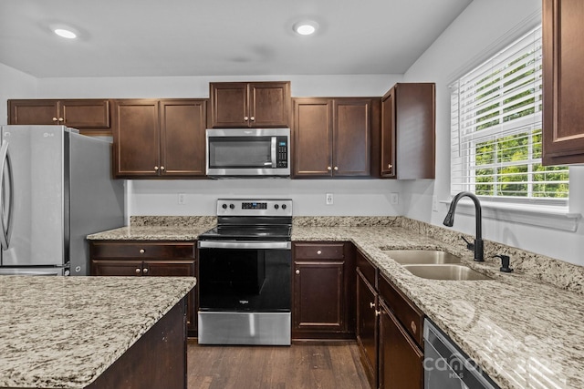 2021 Tarzi Ln, Charlotte, NC 28215 - kitchen featuring appliances with stainless steel finishes, dark wood-style flooring, light stone countertops, recessed lighting, and dark brown cabinets