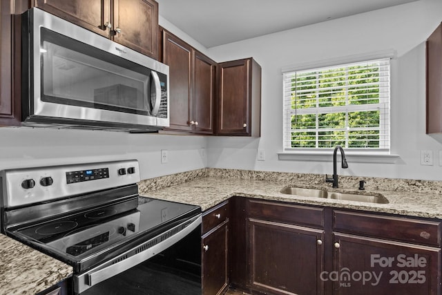 2021 Tarzi Ln, Charlotte, NC 28215 - kitchen featuring appliances with stainless steel finishes, dark brown cabinets, and light stone countertops
