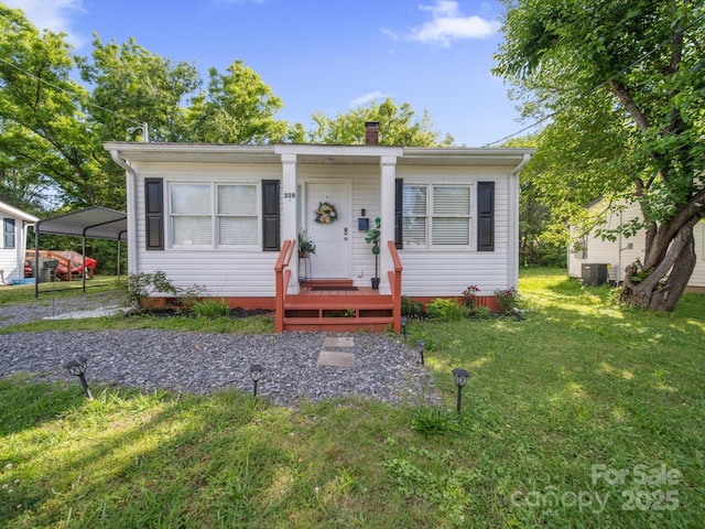 339 Arnold St, Rock Hill, SC 29730 - bungalow-style house featuring a front yard, a chimney, central AC unit, and a detached carport