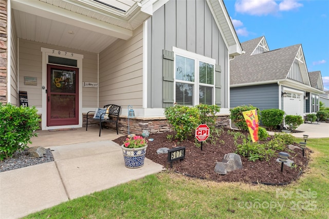 5079 Skyfest Dr, Charlotte, NC 28215 - property entrance featuring board and batten siding, a shingled roof, a porch, and an attached garage