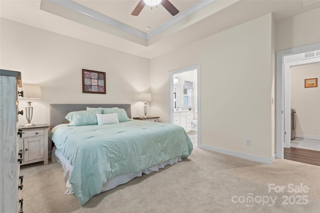 5079 Skyfest Dr, Charlotte, NC 28215 - bedroom featuring carpet floors, a tray ceiling, baseboards, and ensuite bathroom