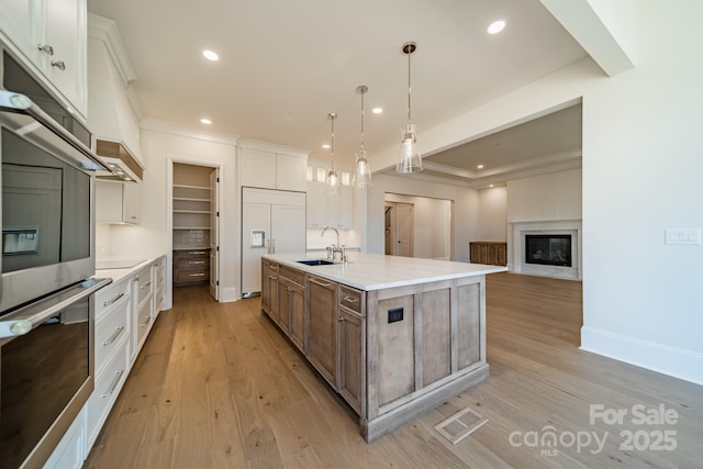 608 Deodar Cedar Dr Unit 69, Matthews, NC 28104 - kitchen with double oven, a sink, paneled built in fridge, recessed lighting, and light wood-style floors