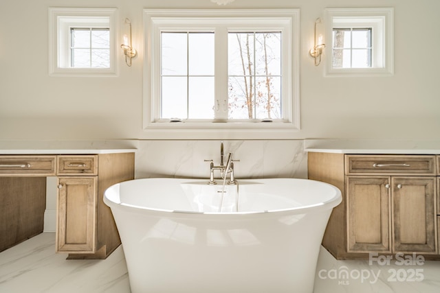 608 Deodar Cedar Dr Unit 69, Matthews, NC 28104 - full bathroom with a freestanding bath, healthy amount of natural light, marble finish flooring, and vanity