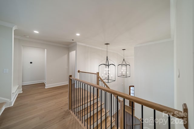 608 Deodar Cedar Dr Unit 69, Matthews, NC 28104 - hallway with an upstairs landing, a chandelier, ornamental molding, wood finished floors, and recessed lighting