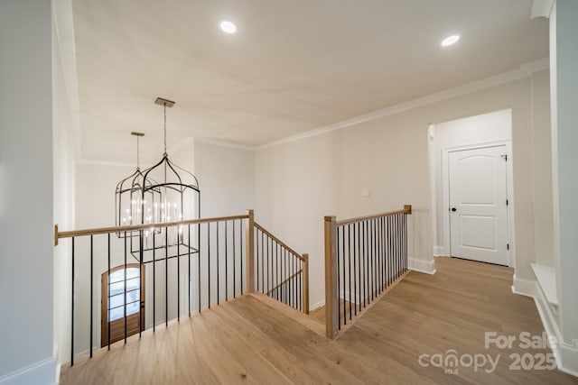 608 Deodar Cedar Dr Unit 69, Matthews, NC 28104 - corridor featuring an upstairs landing, a chandelier, wood finished floors, ornamental molding, and recessed lighting