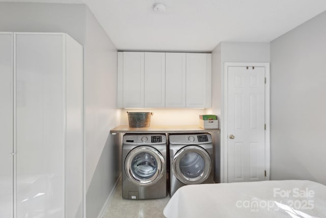 3721 Conway Ave, Charlotte, NC 28209 - laundry room featuring washing machine and dryer, baseboards, and cabinet space