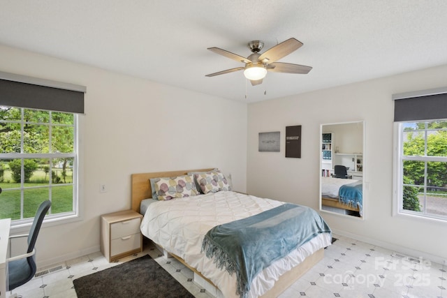 3721 Conway Ave, Charlotte, NC 28209 - bedroom with multiple windows, baseboards, and a ceiling fan