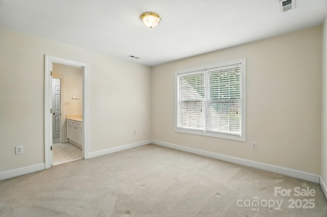 201 Limerick Dr, Matthews, NC 28104 - unfurnished bedroom featuring light carpet, baseboards, and connected bathroom