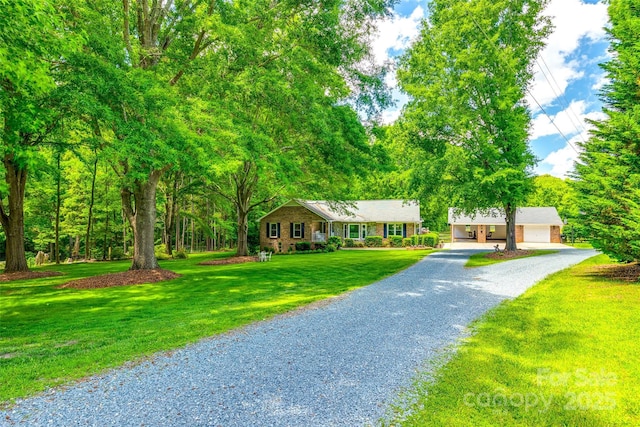 7712 Old Waxhaw Monroe Rd, Waxhaw, NC 28173 - ranch-style home featuring gravel driveway, a front lawn, and a garage