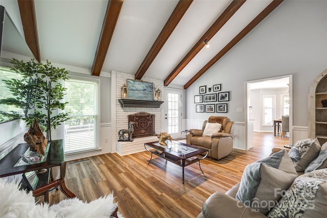 7712 Old Waxhaw Monroe Rd, Waxhaw, NC 28173 - living room with a wainscoted wall, beam ceiling, a brick fireplace, and light wood finished floors