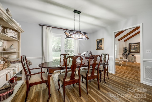 7712 Old Waxhaw Monroe Rd, Waxhaw, NC 28173 - dining area featuring a chandelier, wood finished floors, and lofted ceiling