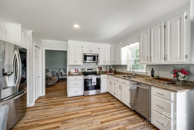 7712 Old Waxhaw Monroe Rd, Waxhaw, NC 28173 - kitchen featuring stainless steel appliances, a sink, white cabinets, dark stone countertops, and recessed lighting