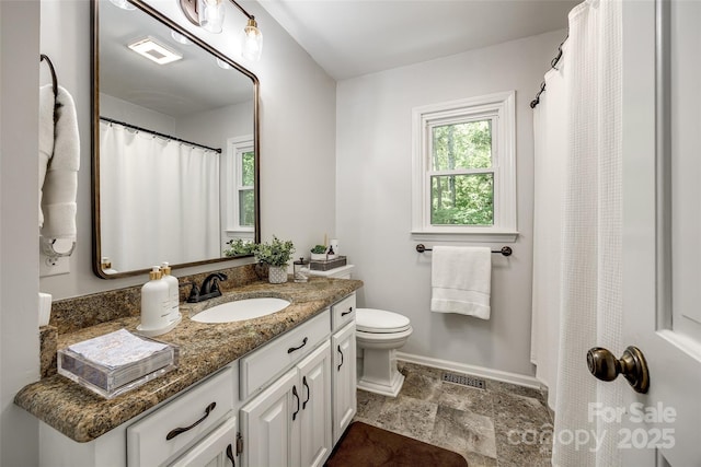 7712 Old Waxhaw Monroe Rd, Waxhaw, NC 28173 - full bath with vanity, stone tile flooring, toilet, and baseboards