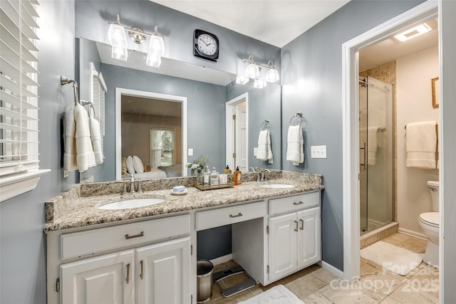 7712 Old Waxhaw Monroe Rd, Waxhaw, NC 28173 - full bath with toilet, double vanity, a shower stall, tile patterned floors, and ensuite bath