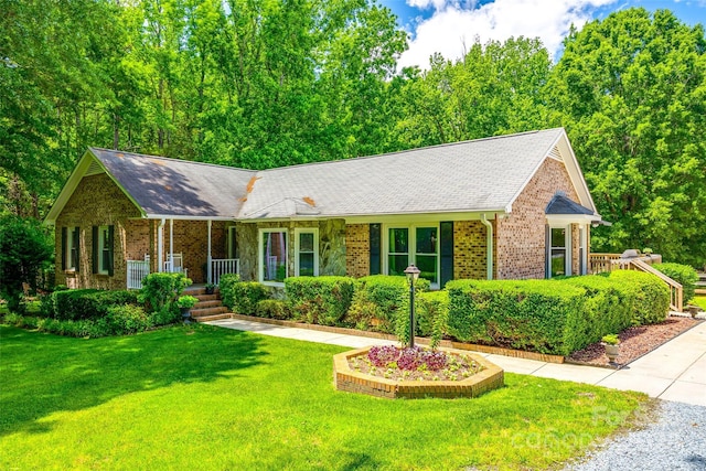 7712 Old Waxhaw Monroe Rd, Waxhaw, NC 28173 - ranch-style home featuring covered porch, brick siding, a front yard, and roof with shingles