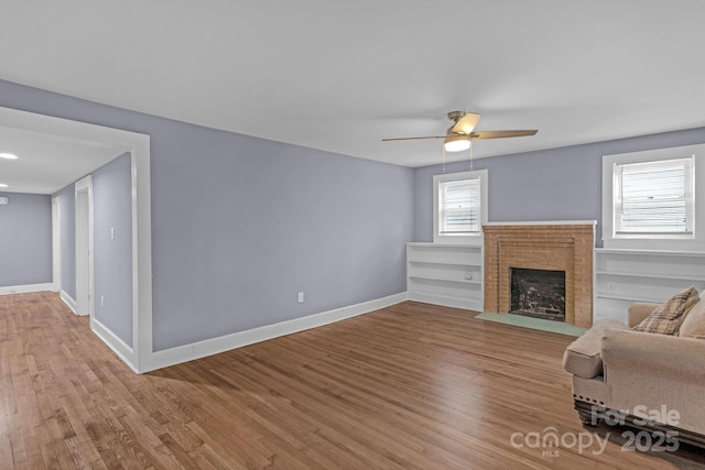 222 W Mccubbins St, Salisbury, NC 28144 - living room with baseboards, wood finished floors, a brick fireplace, and ceiling fan