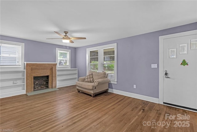 222 W Mccubbins St, Salisbury, NC 28144 - living room featuring wood finished floors, a ceiling fan, a fireplace, and baseboards