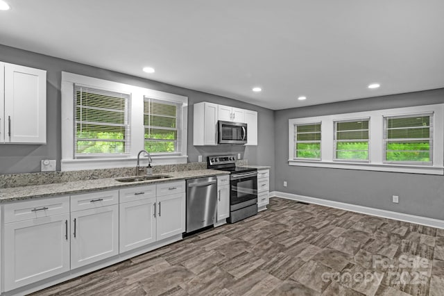 222 W Mccubbins St, Salisbury, NC 28144 - kitchen with appliances with stainless steel finishes, a sink, recessed lighting, white cabinets, and plenty of natural light