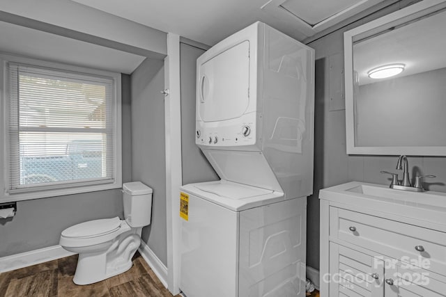 222 W Mccubbins St, Salisbury, NC 28144 - bathroom featuring stacked washer / dryer, baseboards, vanity, toilet, and wood finished floors