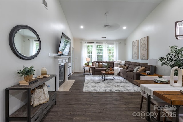 4637 Willow Glen Rd, Harrisburg, NC 28075 - living area featuring lofted ceiling, dark wood-style floors, a fireplace with flush hearth, and recessed lighting