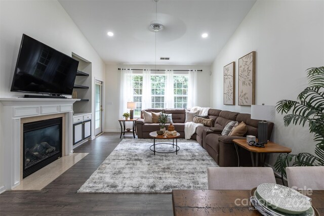 4637 Willow Glen Rd, Harrisburg, NC 28075 - living area featuring vaulted ceiling, dark wood finished floors, a high end fireplace, recessed lighting, and built in shelves