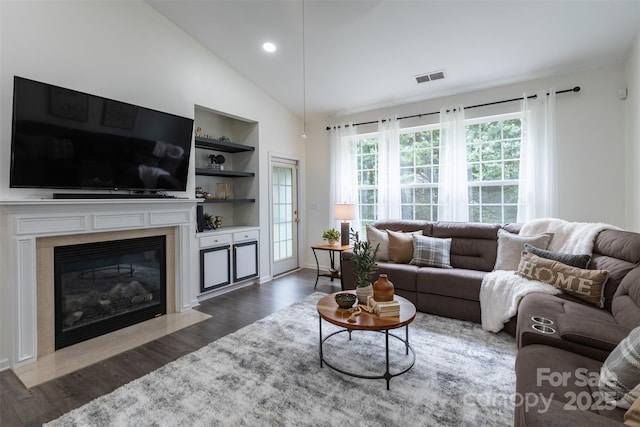 4637 Willow Glen Rd, Harrisburg, NC 28075 - living room featuring dark wood finished floors, a high end fireplace, baseboards, high vaulted ceiling, and built in features