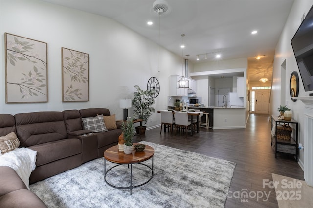 4637 Willow Glen Rd, Harrisburg, NC 28075 - living room featuring dark wood finished floors, baseboards, recessed lighting, and lofted ceiling