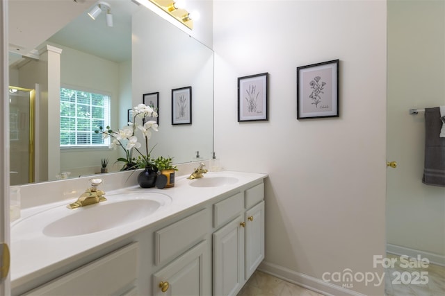 4637 Willow Glen Rd, Harrisburg, NC 28075 - bathroom featuring double vanity, a shower with shower door, and baseboards