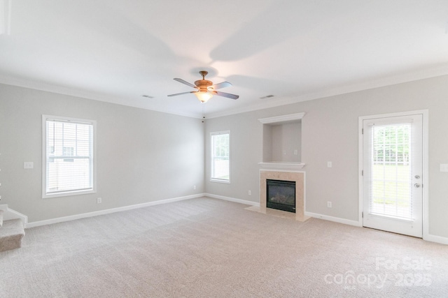 9641 Bellamy Pl NW, Concord, NC 28027 - unfurnished living room with crown molding, light colored carpet, a premium fireplace, and plenty of natural light