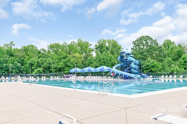 9641 Bellamy Pl NW, Concord, NC 28027 - community pool with a water slide, a patio area, and view of wooded area