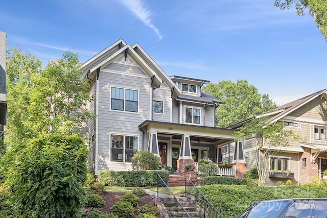 2221 Kenmore Ave, Charlotte, NC 28204 - craftsman-style house with covered porch, a ceiling fan, and stairs