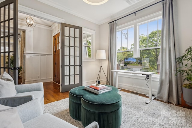 2221 Kenmore Ave, Charlotte, NC 28204 - sitting room featuring french doors, healthy amount of natural light, ornamental molding, and wood finished floors