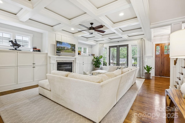 2221 Kenmore Ave, Charlotte, NC 28204 - living room with wood finished floors, a glass covered fireplace, beamed ceiling, a ceiling fan, and recessed lighting
