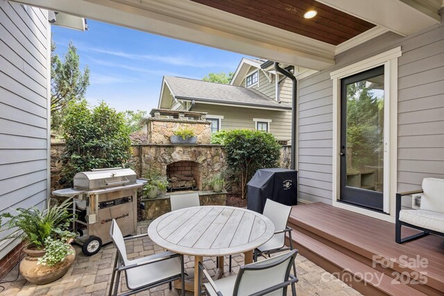 2221 Kenmore Ave, Charlotte, NC 28204 - view of patio / terrace featuring an outdoor stone fireplace, area for grilling, and outdoor dining space