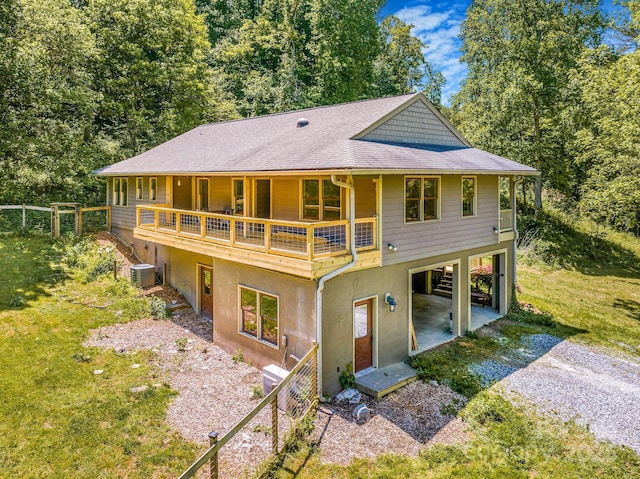 276 Morgan Branch Rd, Marshall, NC 28753 - rear view of property featuring a carport, central air condition unit, driveway, a shingled roof, and a lawn
