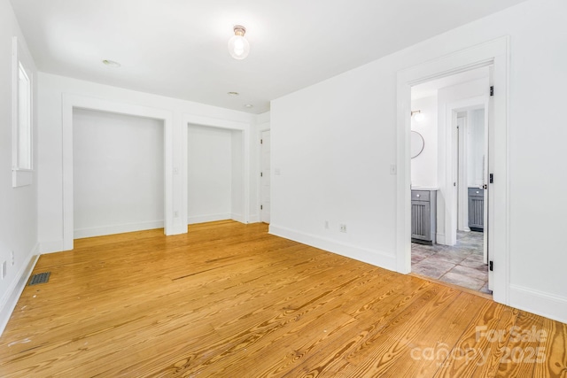 276 Morgan Branch Rd, Marshall, NC 28753 - unfurnished bedroom with light wood-style floors, baseboards, and ensuite bath