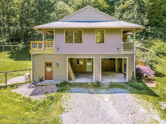 276 Morgan Branch Rd, Marshall, NC 28753 - view of front of property featuring gravel driveway, a patio, a garage, stucco siding, and a shingled roof