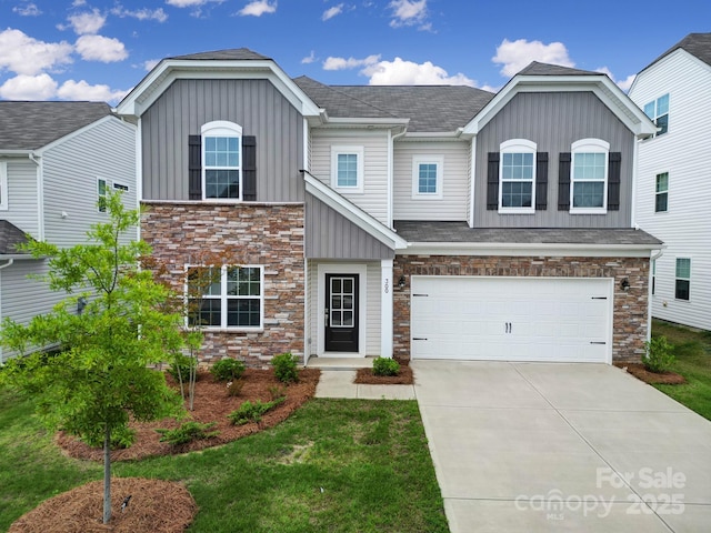 300 Kennerly Center Dr, Mooresville, NC 28115 - view of front of property with board and batten siding, stone siding, concrete driveway, a garage, and roof with shingles