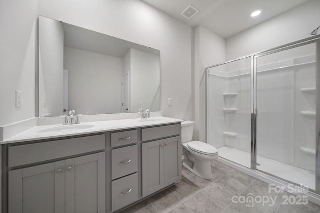 300 Kennerly Center Dr, Mooresville, NC 28115 - full bathroom featuring toilet, double vanity, a shower stall, and tile patterned flooring