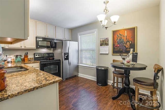 1804 Fairlawn Ct, Rock Hill, SC 29732 - kitchen featuring black appliances, light stone countertops, a chandelier, dark wood-style flooring, and baseboards