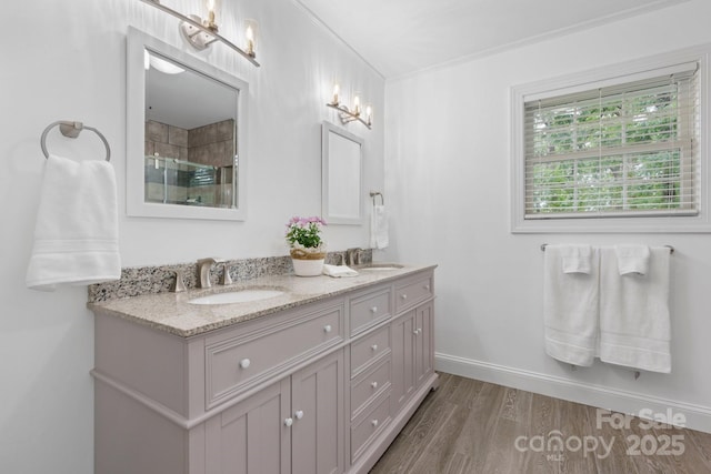 1035 15th Ave NW, Hickory, NC 28601 - full bathroom featuring double vanity, wood finished floors, tiled shower, ornamental molding, and baseboards