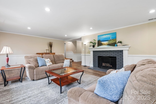 1035 15th Ave NW, Hickory, NC 28601 - living room featuring ornamental molding, wainscoting, recessed lighting, wood finished floors, and a fireplace