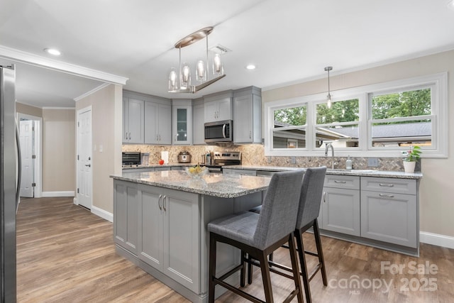 1035 15th Ave NW, Hickory, NC 28601 - kitchen featuring stainless steel appliances, gray cabinets, baseboards, backsplash, and wood finished floors